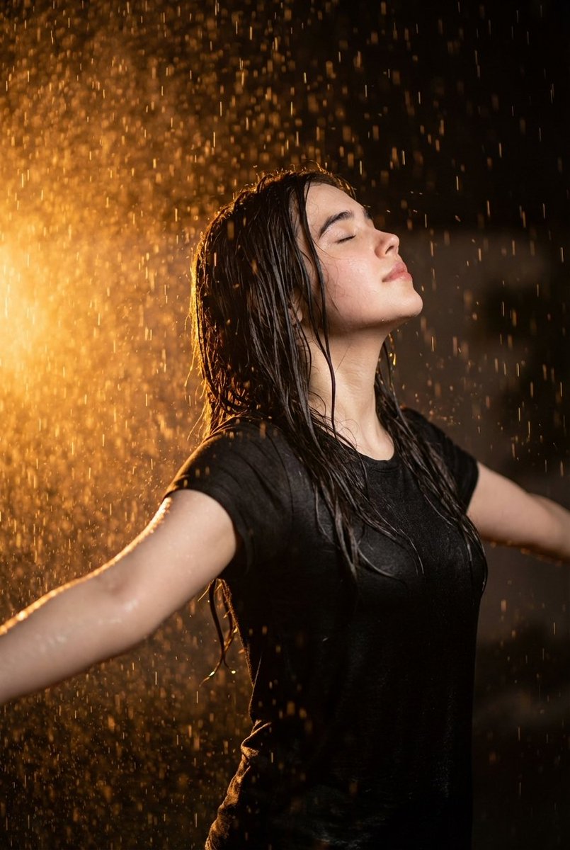 Cinematic portrait of woman in heavy rain at night