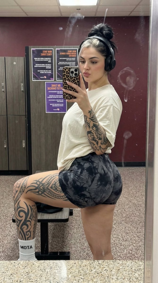 Athletic Woman Post-Workout Mirror Selfie with Tattoos