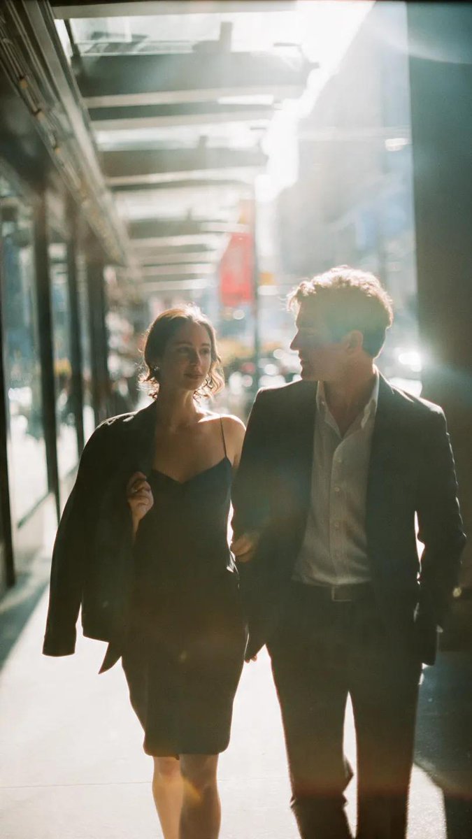 A cinematic candid medium shot portrait of a man and a woman walking