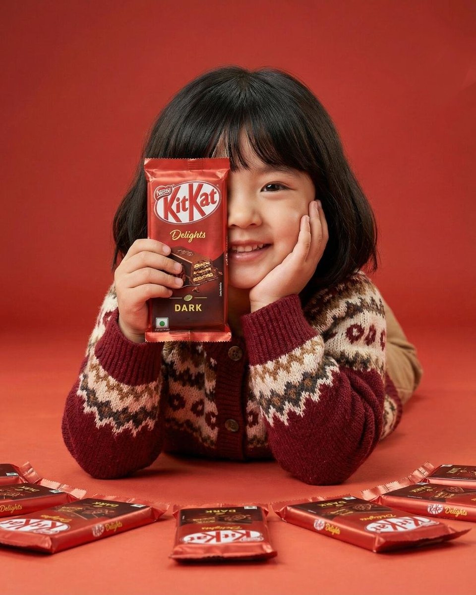 A cute young girl with short black hair and bangs smiling while